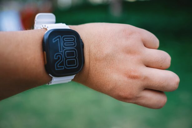 A person is wearing a white smartwatch.