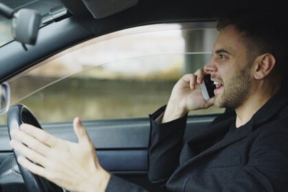 Man talking on phone while driving car