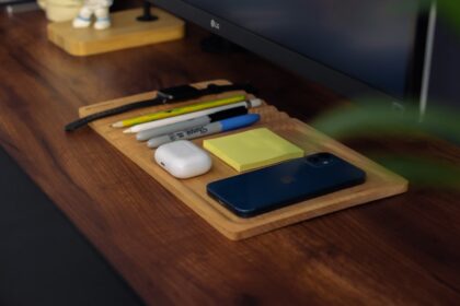 a wooden desk with a computer monitor and a keyboard