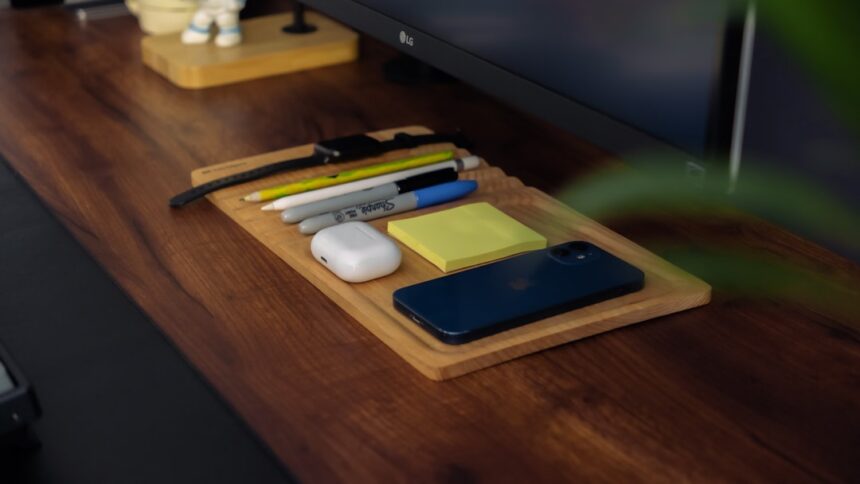 a wooden desk with a computer monitor and a keyboard