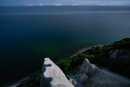 a rocky cliff overlooking a body of water