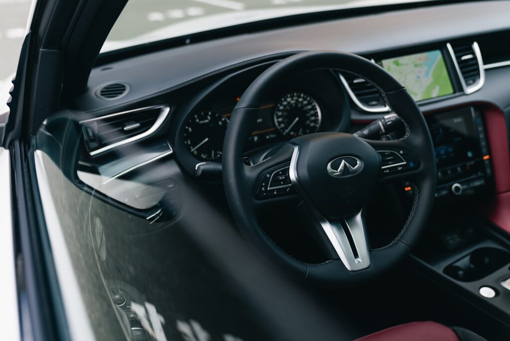 Modern car interior with leather seats and navigation screen.