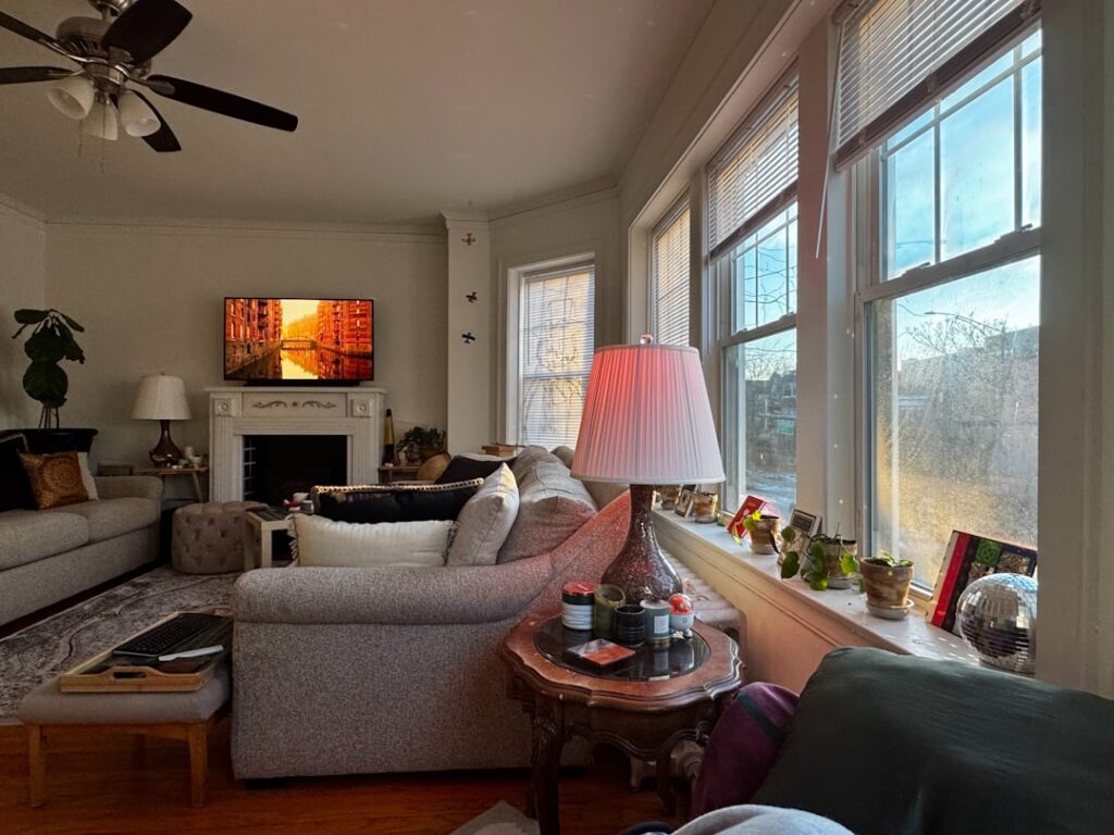 Cozy living room with fireplace and large windows.