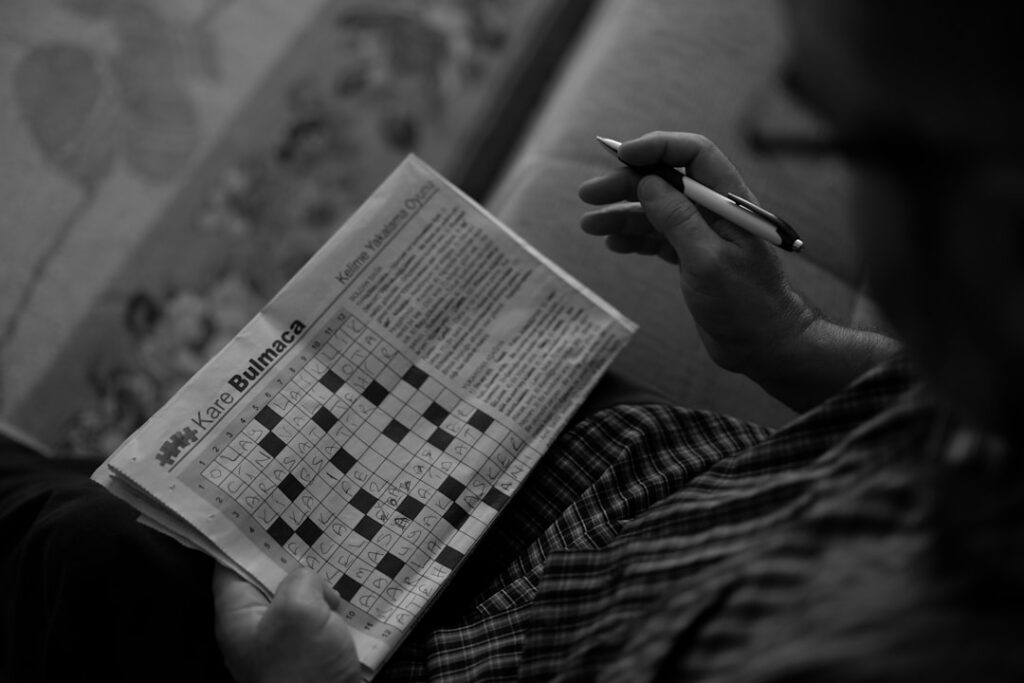 a man sitting on a couch reading a newspaper
