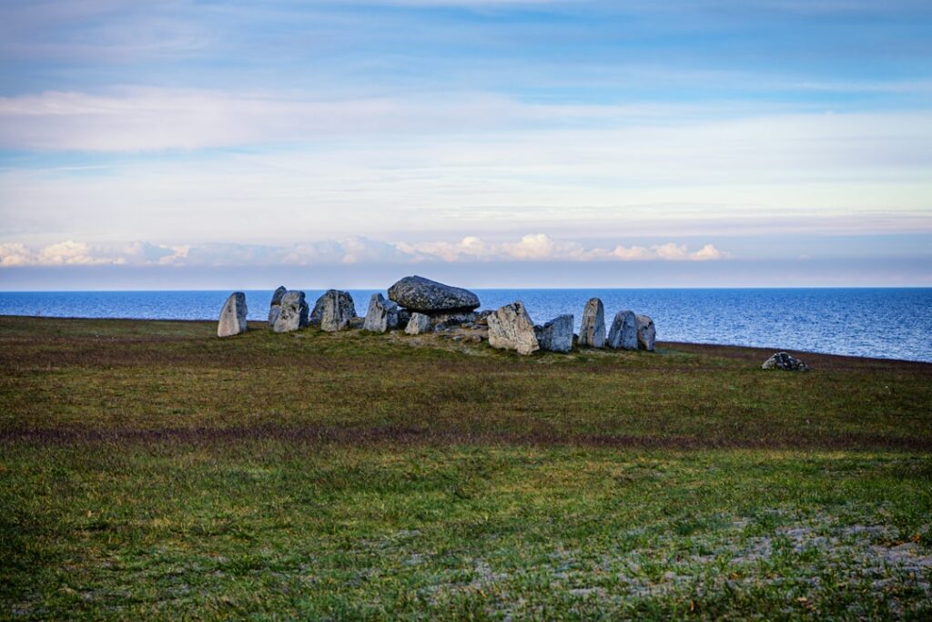 Ancient stone circle on a grassy coastline by the sea