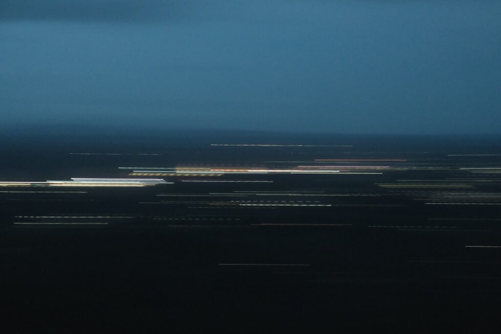 Blurred city lights at dusk with dark sky