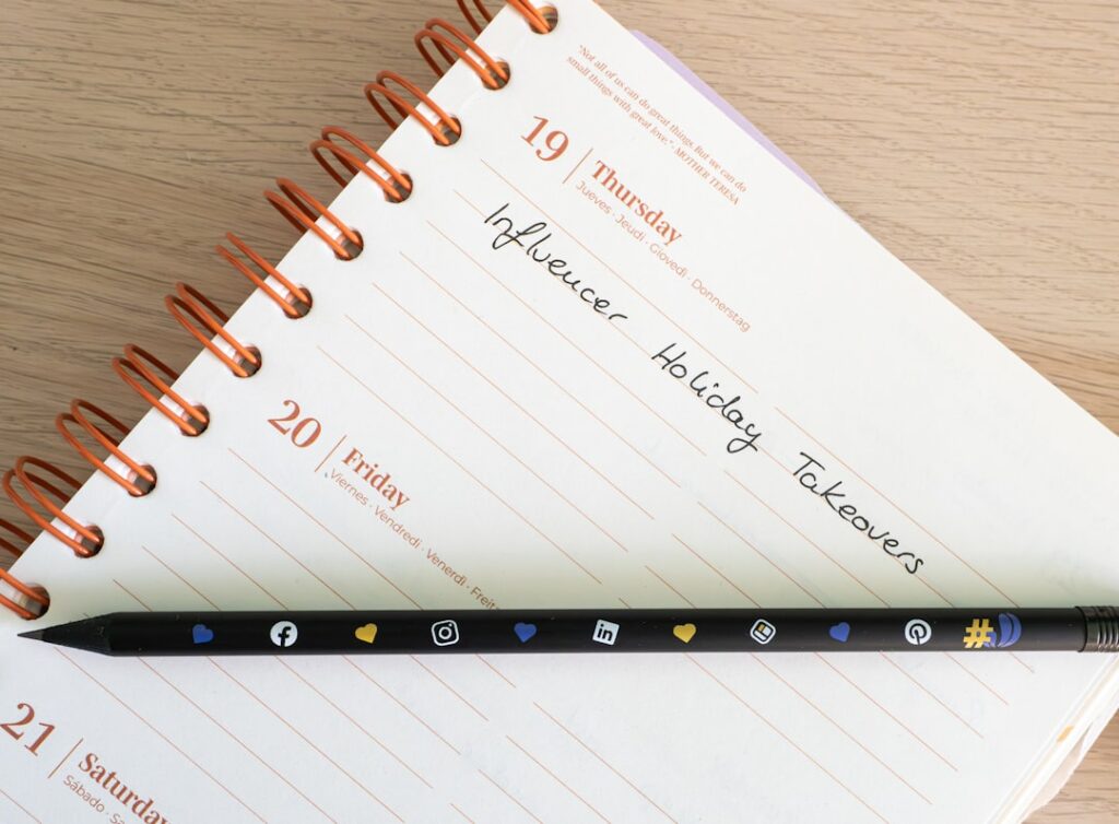 a pen sitting on top of a notebook on a table