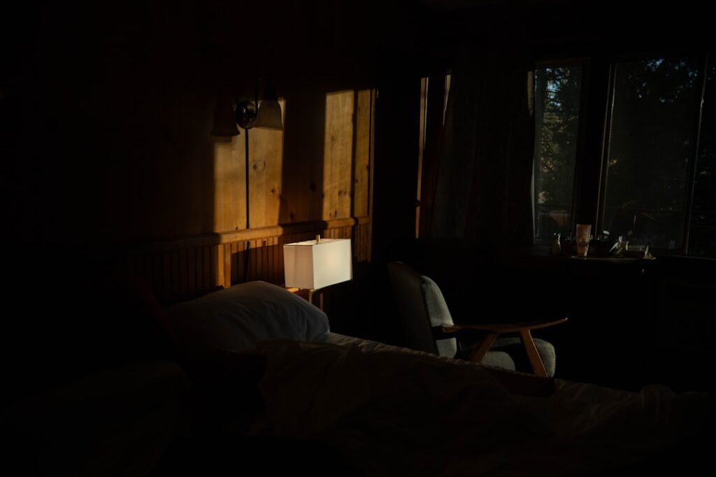 Dimly lit bedroom with sunlight through window