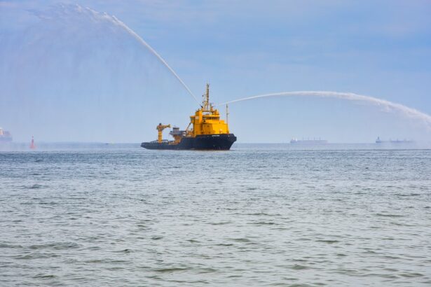 a large yellow boat spraying water on the ocean