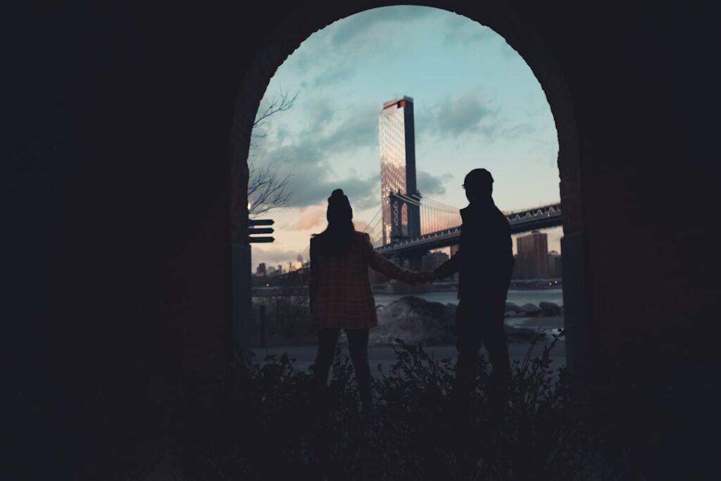 a couple of people standing in front of a window