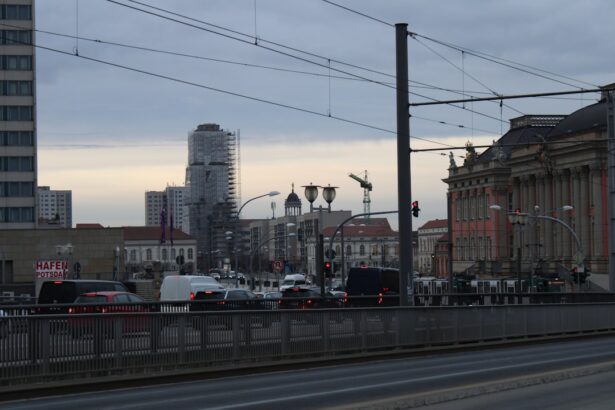a city street filled with lots of traffic next to tall buildings