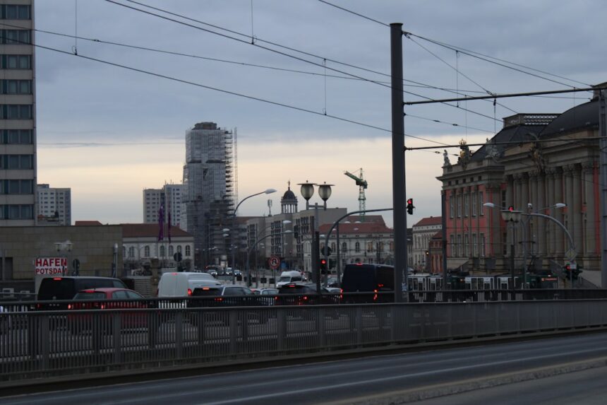 a city street filled with lots of traffic next to tall buildings