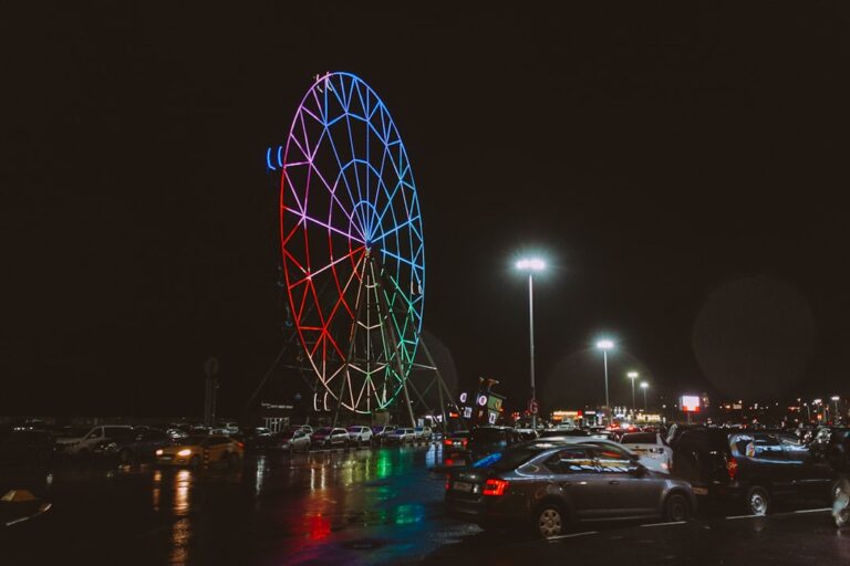 Ferris wheel illuminated with colorful lights at night
