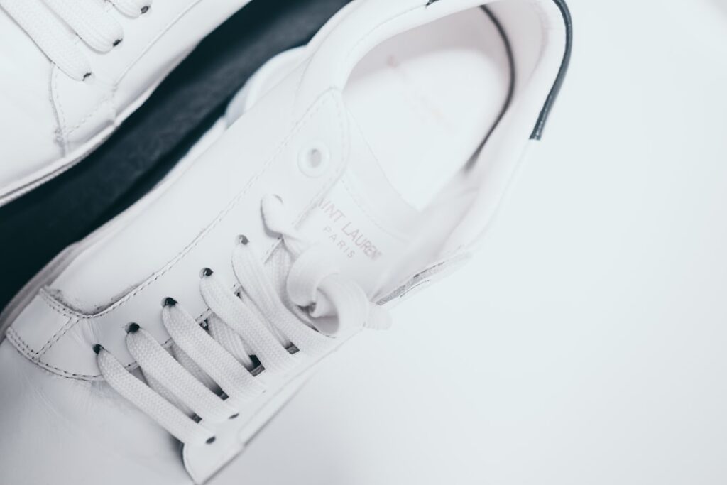 A pair of white shoes sitting on top of a white table