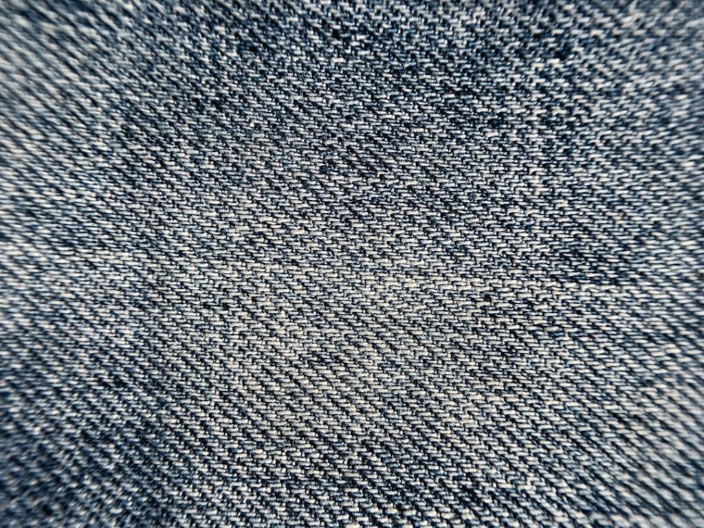 a close up view of a denim fabric texture