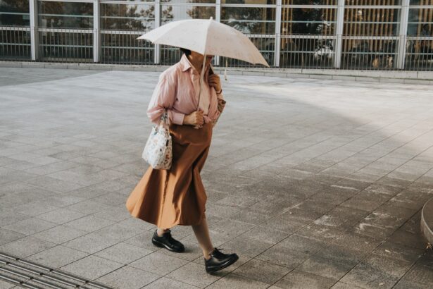 Woman walks outside holding an umbrella.