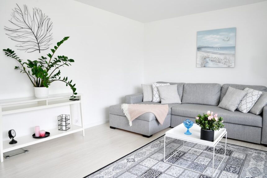 Modern living room with gray sectional and plants.