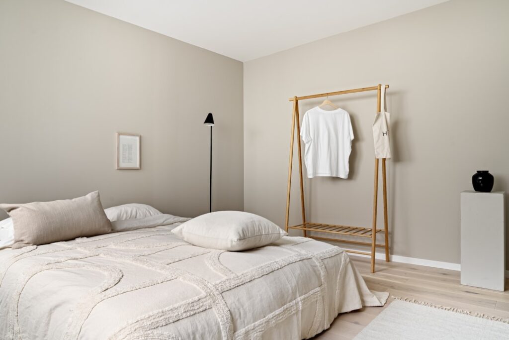 A bedroom with a bed and a mirror