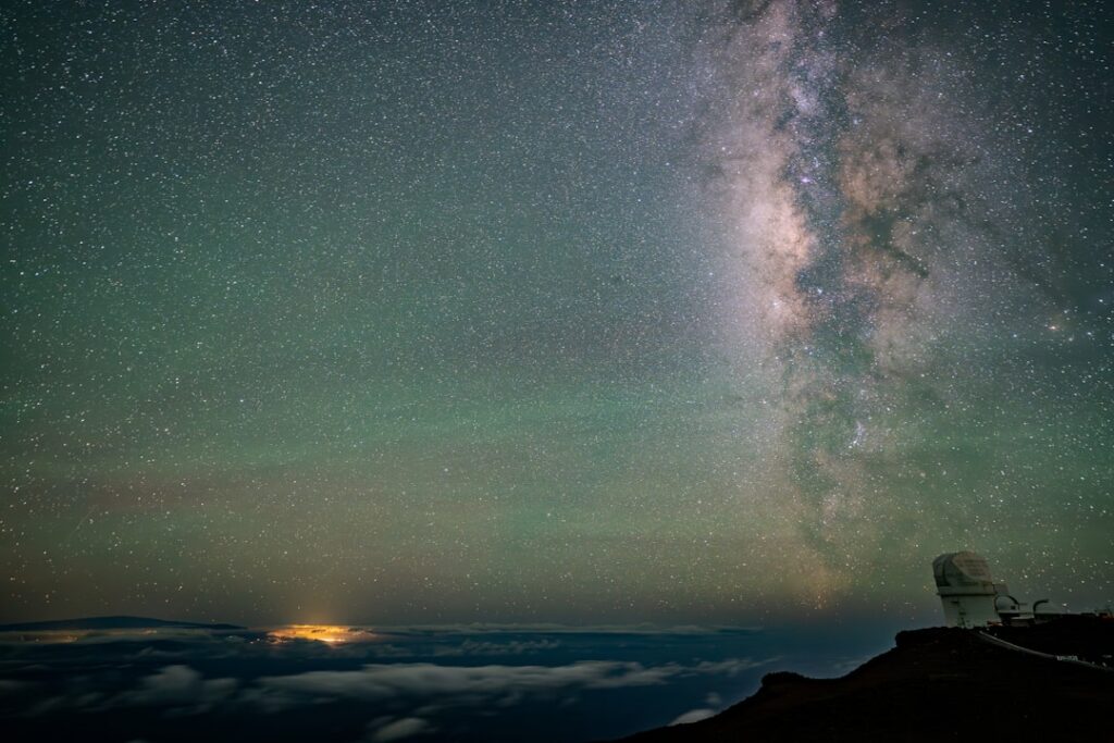 Milky way galaxy above a mountaintop observatory at night
