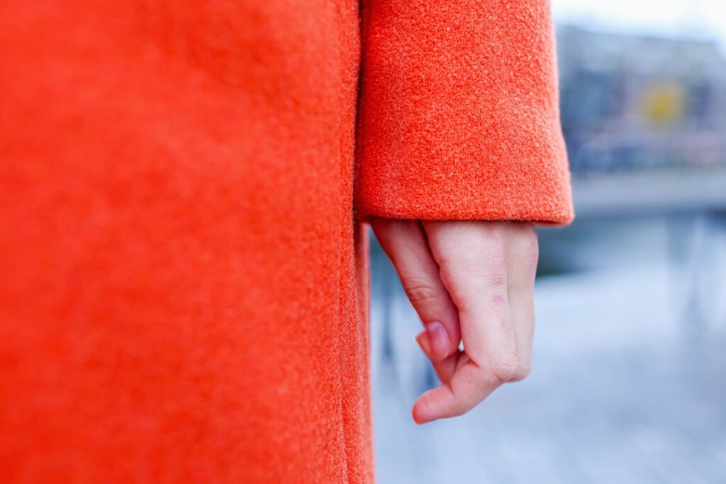 Close up of a person wearing an orange coat