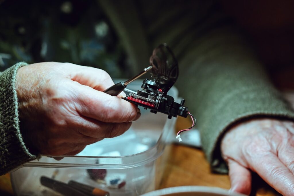 Hands are fixing electronic components.