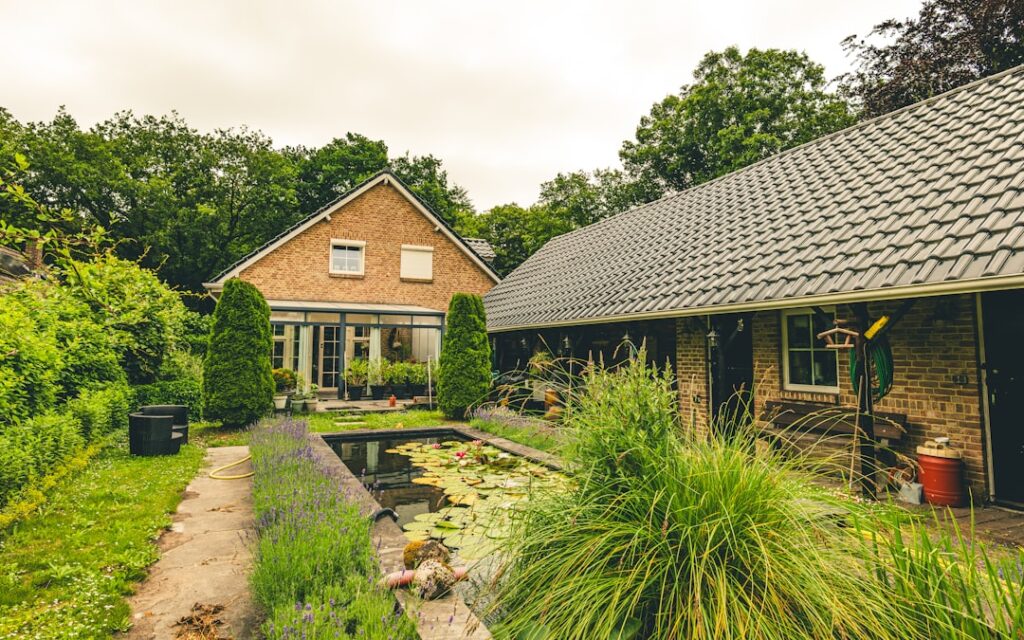 Brick house with a garden and pond
