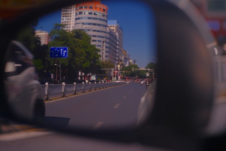 Reflection of a city street in a car's side mirror.