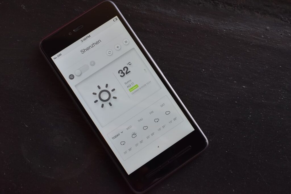 a cell phone with a weather station on the screen