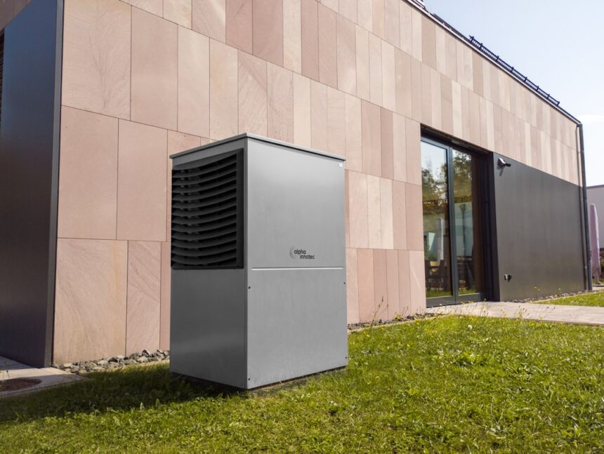 Modern outdoor heat pump unit next to building