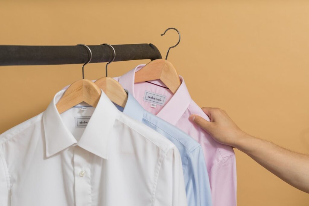 white button up shirt on brown clothes hanger