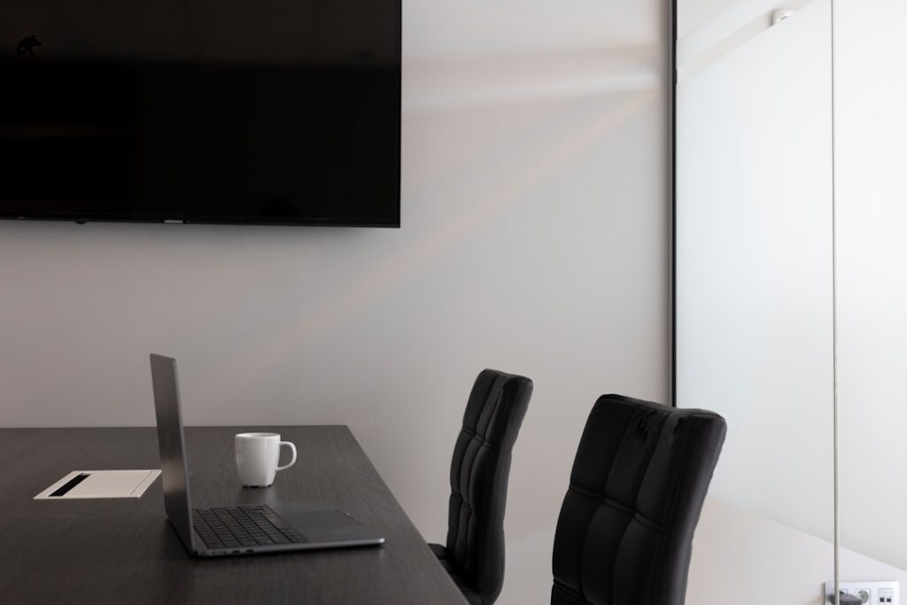 a desk with a laptop and a chair