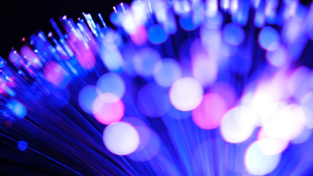 Blury lights illuminate fiber optic cables.