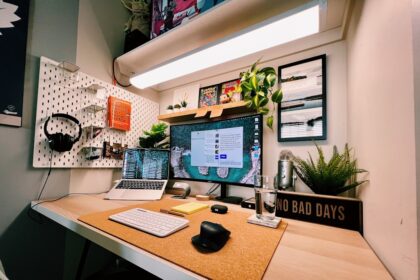 a desk with a laptop and a monitor on it