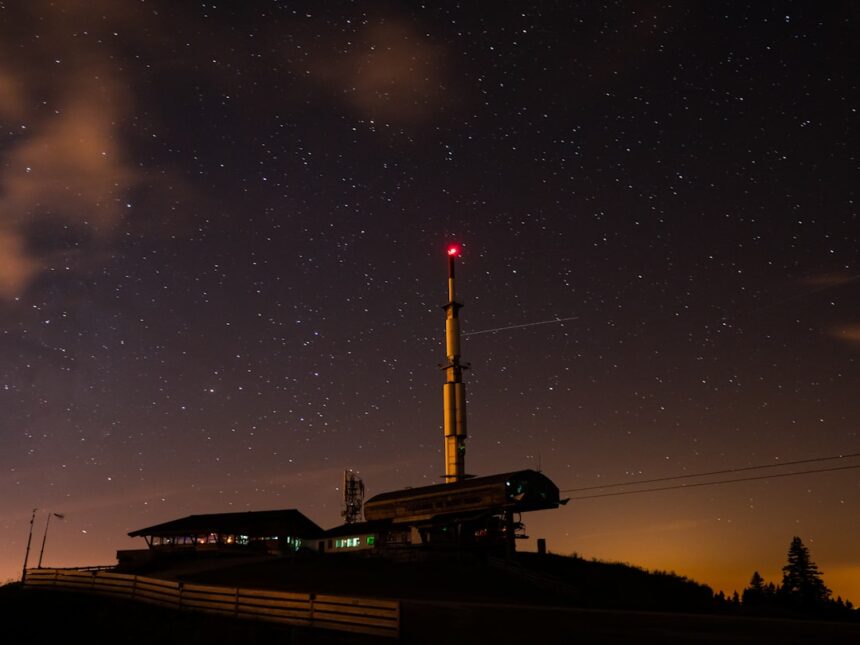 Tower and buildings under starry night sky