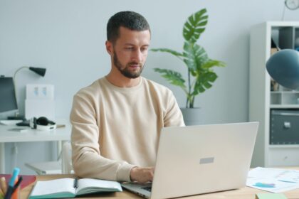 Man working on a laptop at a desk.