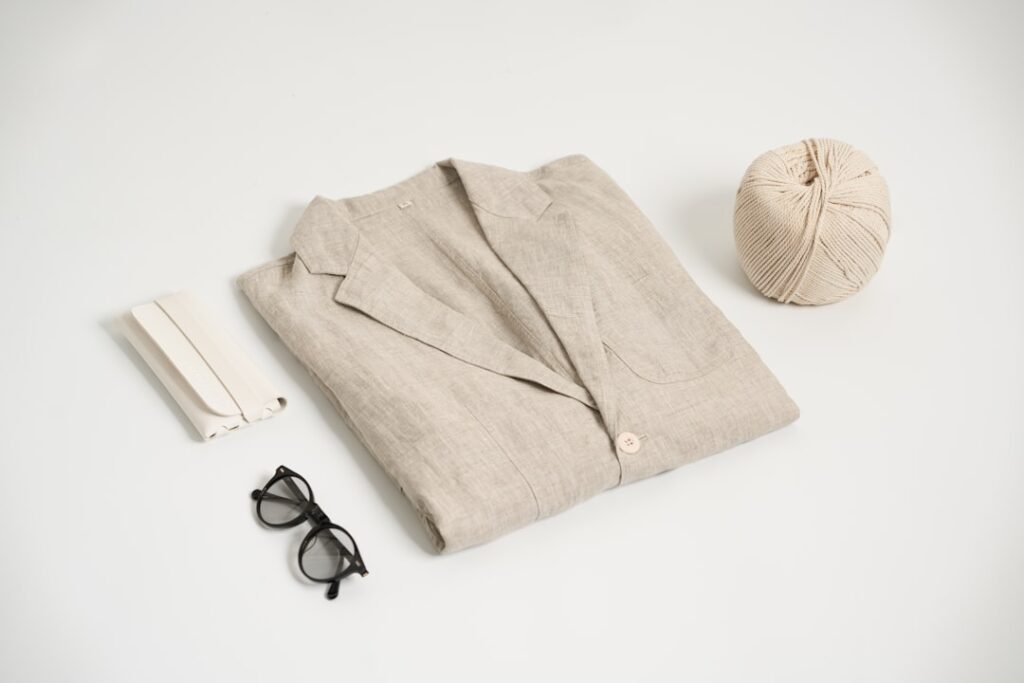 a pair of glasses, a ball of yarn, a pair of sunglasses, and