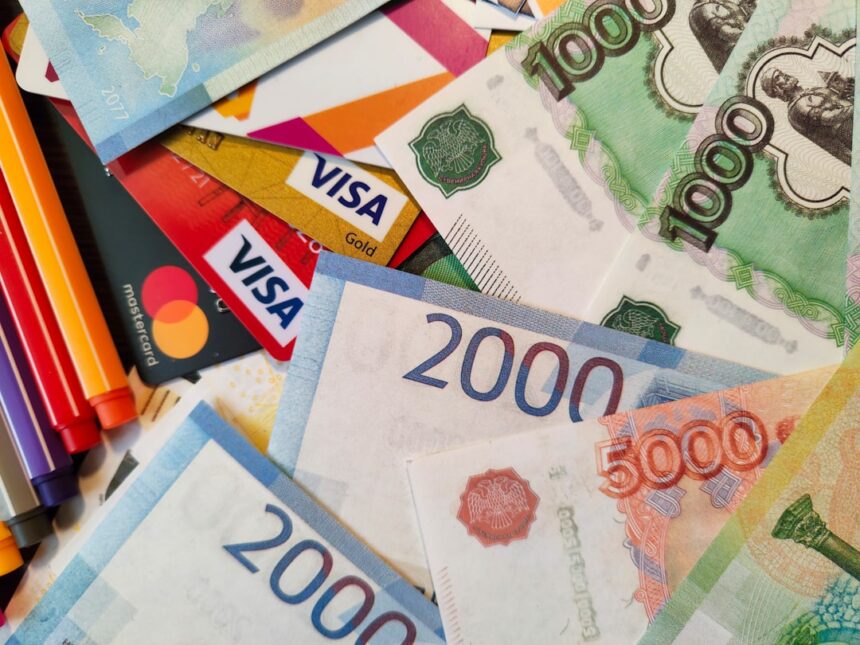 a pile of different currency sitting on top of each other