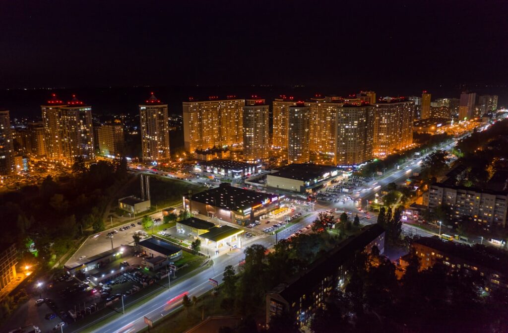 Illuminated city buildings at night with streetlights