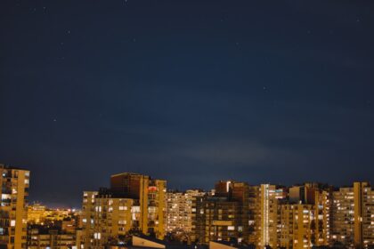 Nighttime cityscape with visible stars.