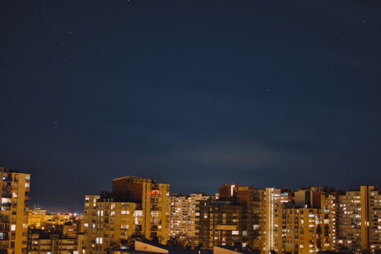 Nighttime cityscape with visible stars.