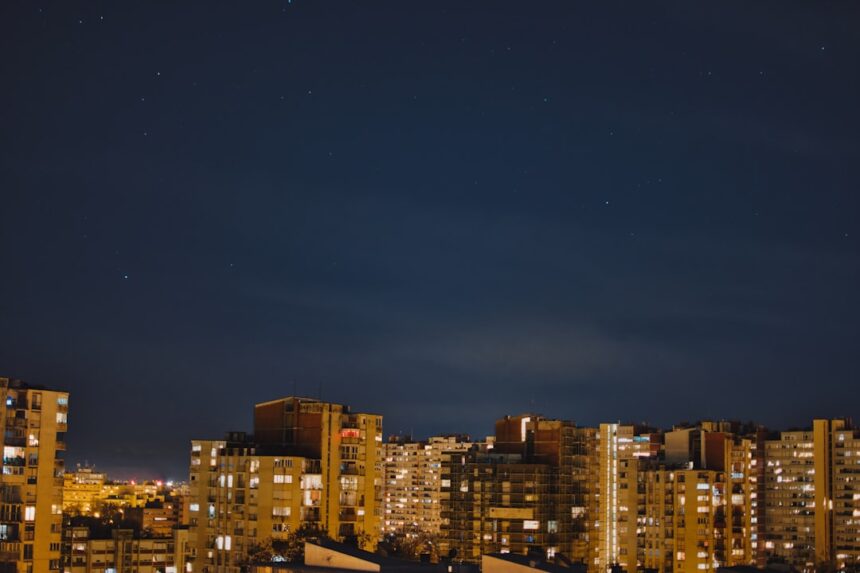 Nighttime cityscape with visible stars.