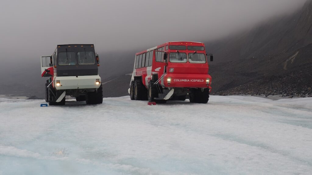 a couple of vehicles that are sitting in the snow