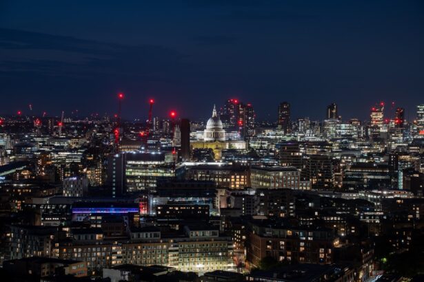 A view of a city at night from the top of a hill