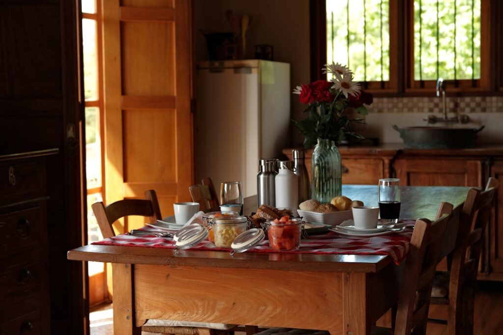 Breakfast table set with food and drinks in kitchen.