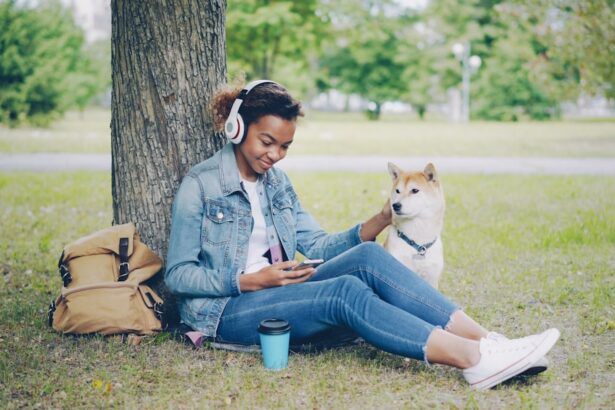 Woman and her dog relax under a tree.