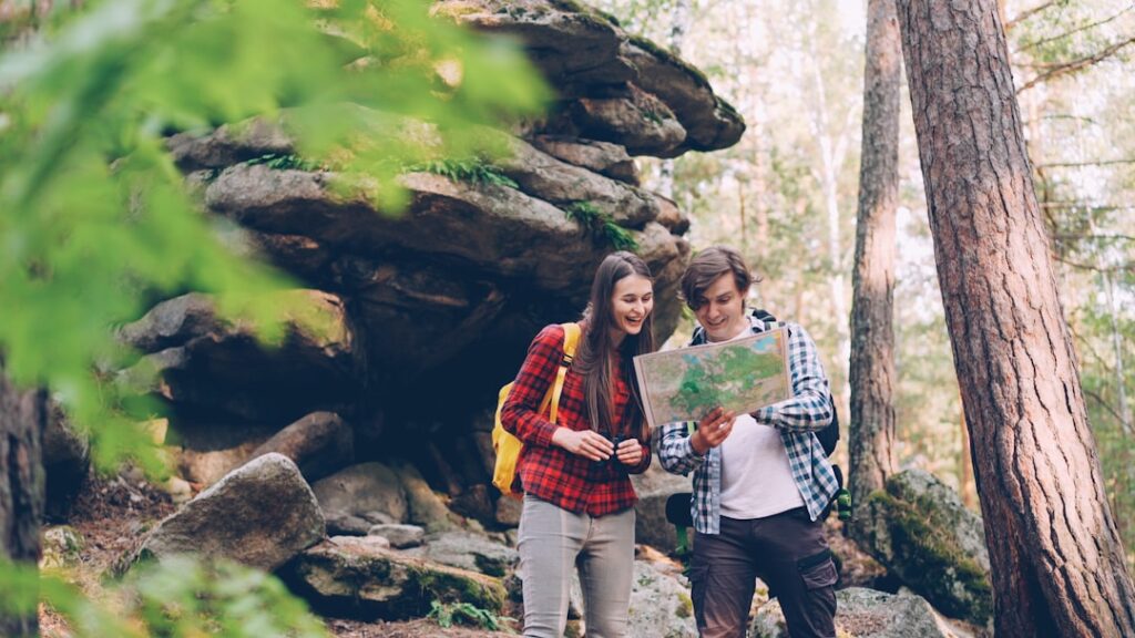 Couple looking at map in a forest