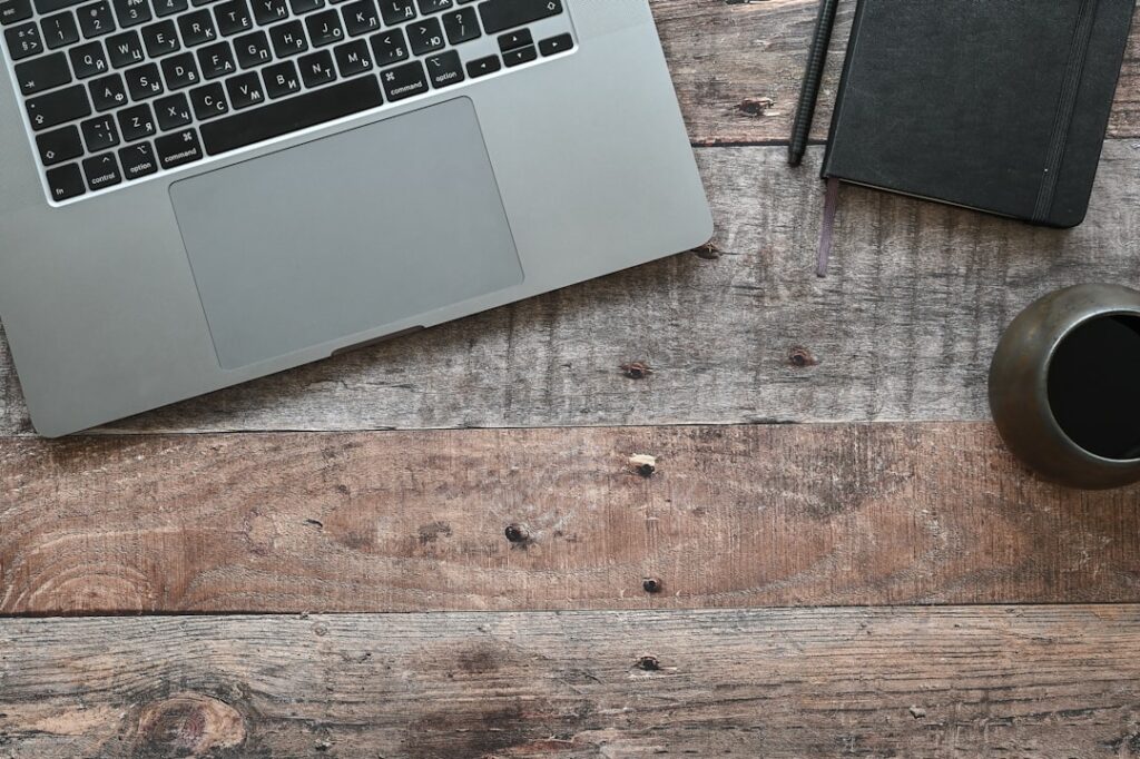 a laptop and a cup on a table