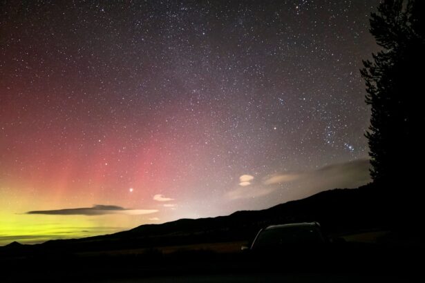 Aurora borealis glows over starry night sky