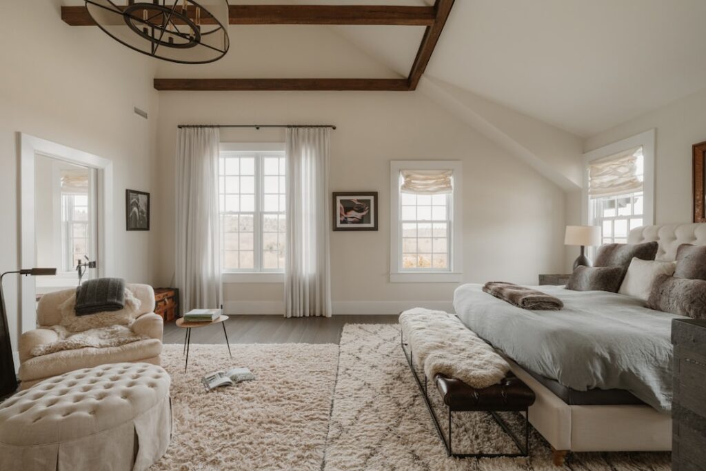 Spacious bedroom with large bed and cozy seating area.
