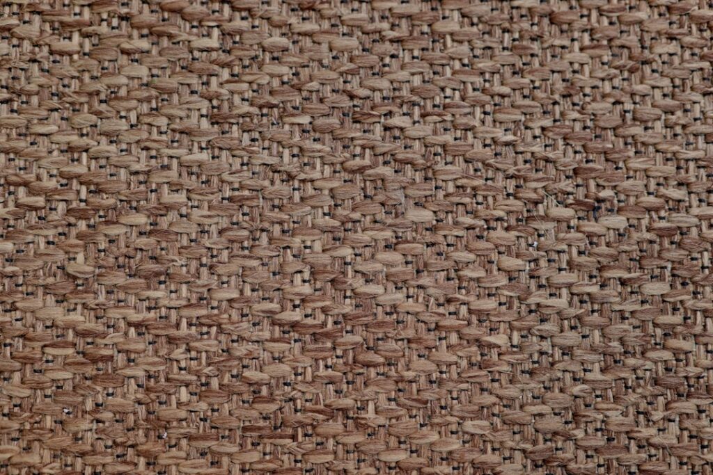 Close-up of woven brown fabric texture.